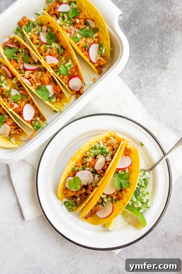 Golden Baked Ground Chicken Tacos 2 Crispy baked ground chicken tacos with cheese, cilantro, and radish