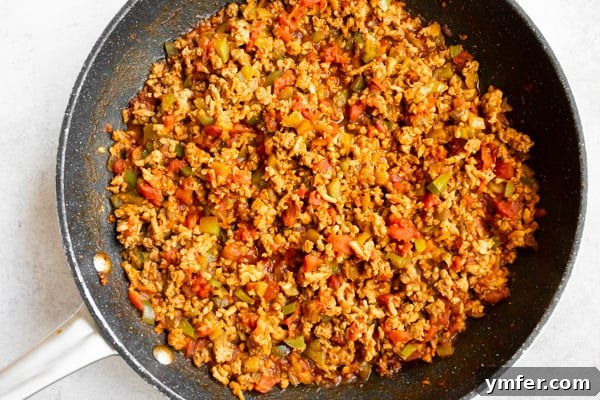 Golden Baked Ground Chicken Tacos 4 A single baked ground chicken taco garnished with fresh toppings