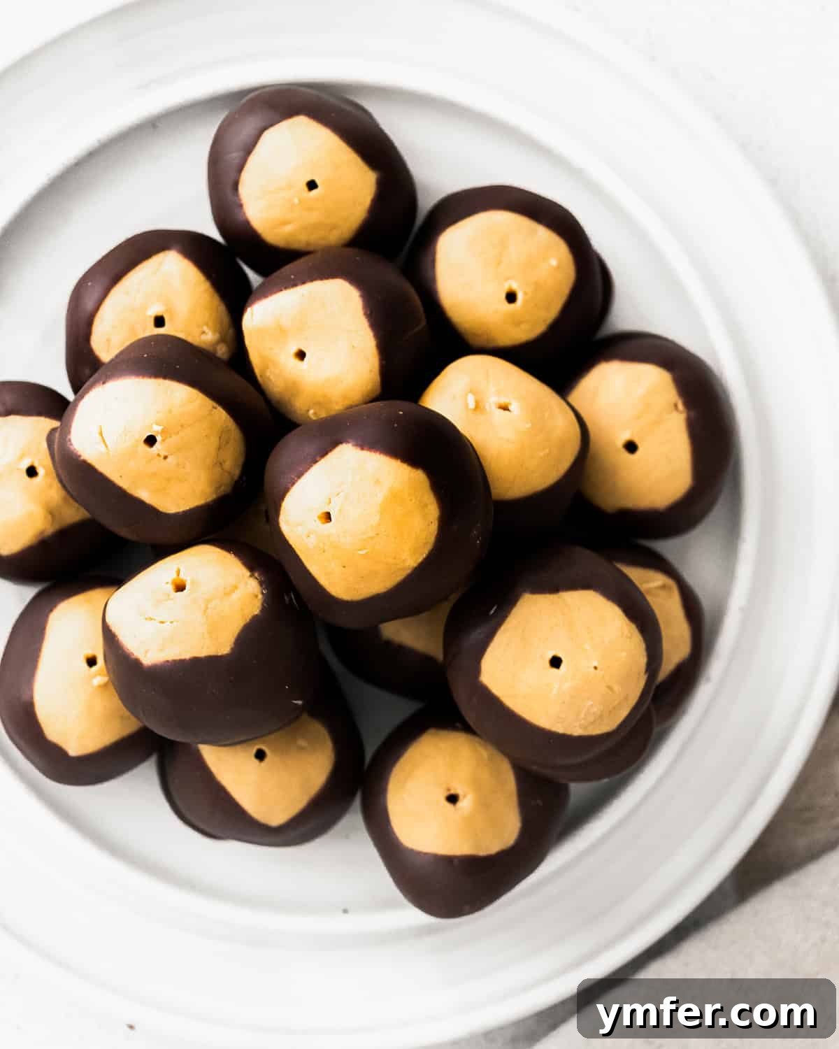 Ultimate Peanut Butter Buckeyes 4 A plate arranged with freshly made peanut butter buckeyes