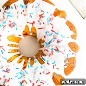 A festive vanilla bundt cake with red, white, and blue sprinkles and a smooth vanilla glaze.