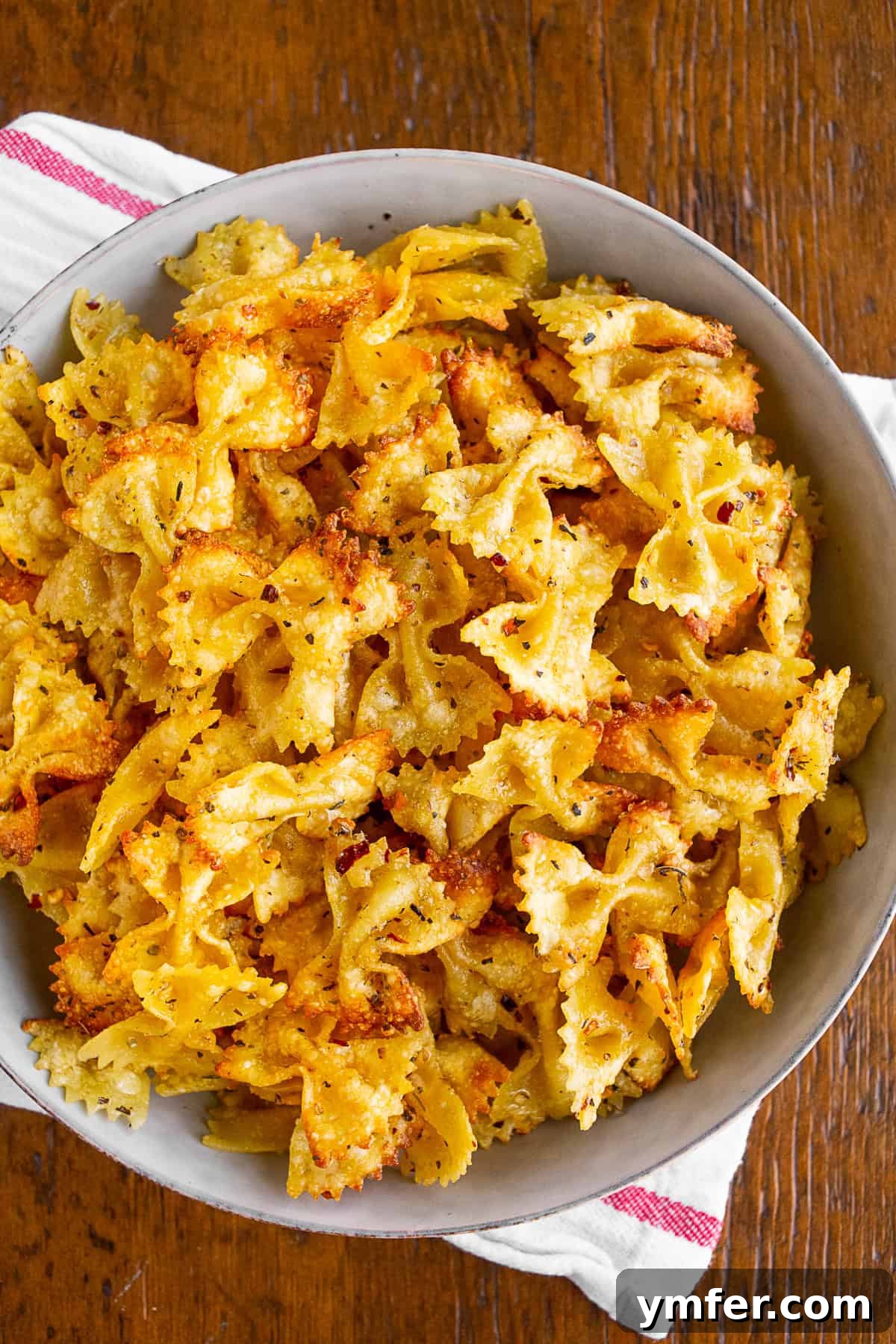Crispy Air Fryer Pasta Chips 5 A grey bowl filled with crispy air fryer pasta chips, ready to be served.