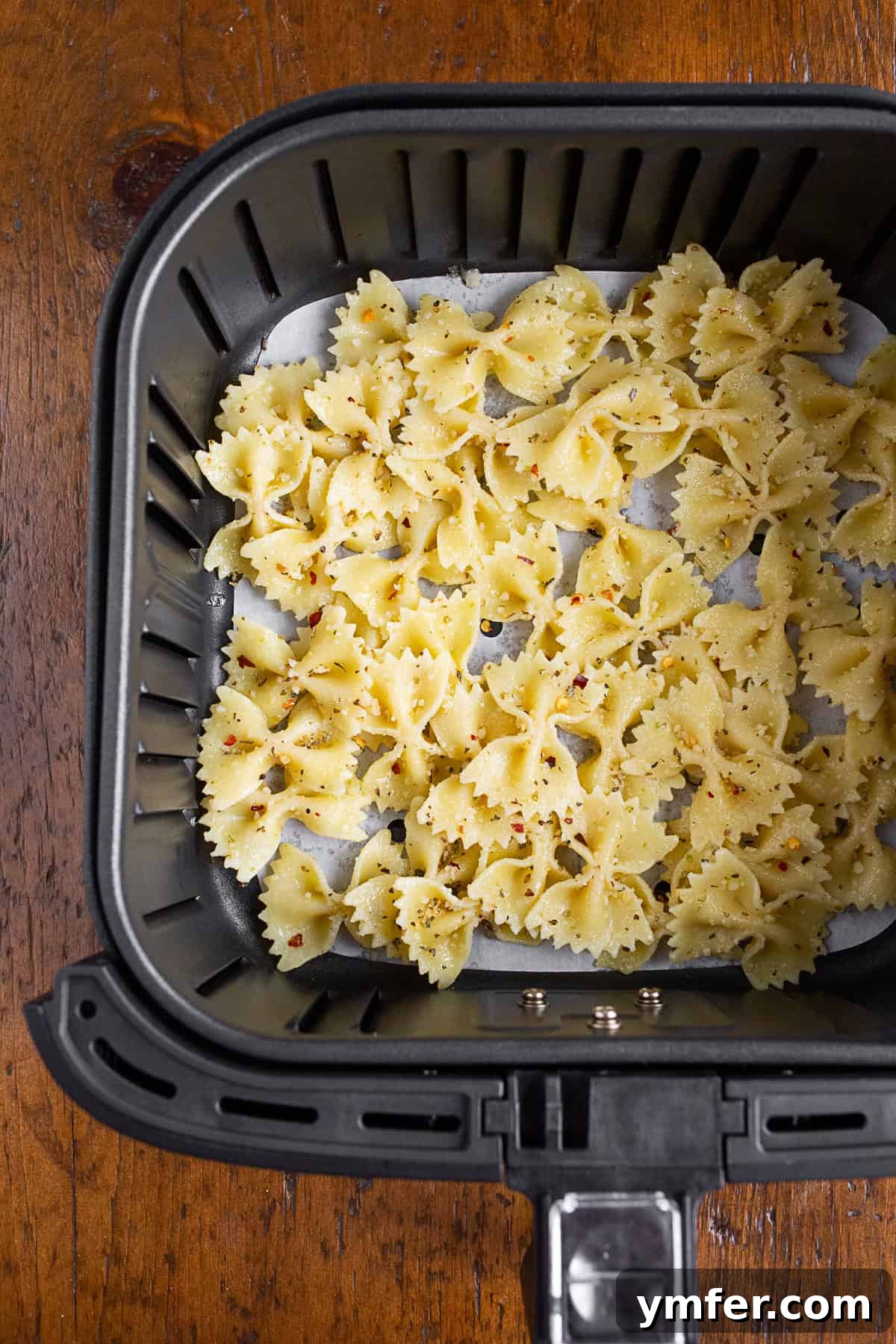 Crispy Air Fryer Pasta Chips 3 Uncooked pasta tossed with olive oil and spices, ready for the air fryer basket.