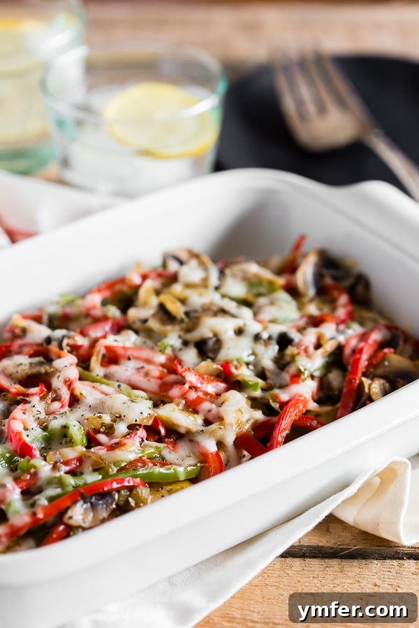 Gentle Braised Chicken 2 Lightly Smothered Chicken in a white casserole dish, featuring tender chicken breast topped with vibrant vegetables and melted cheese, drizzled with homemade honey mustard.