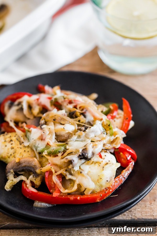 Gentle Braised Chicken 3 A single serving of Lightly Smothered Chicken on a white plate, showcasing tender chicken, melted cheese, and colorful sautéed vegetables.