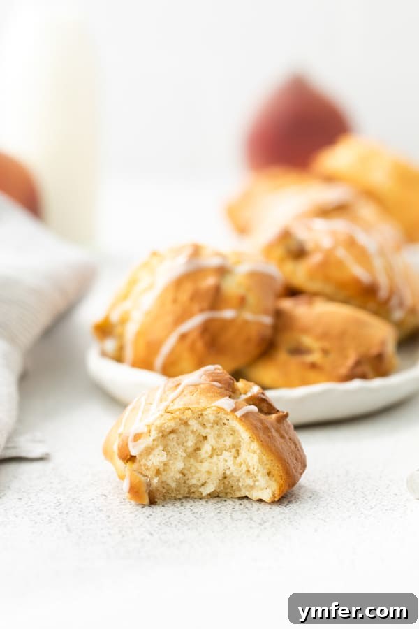 Air-Fried Peachy Delights 5 A perfectly cooked air fryer peach fritter cut in half, revealing the soft, peachy interior.