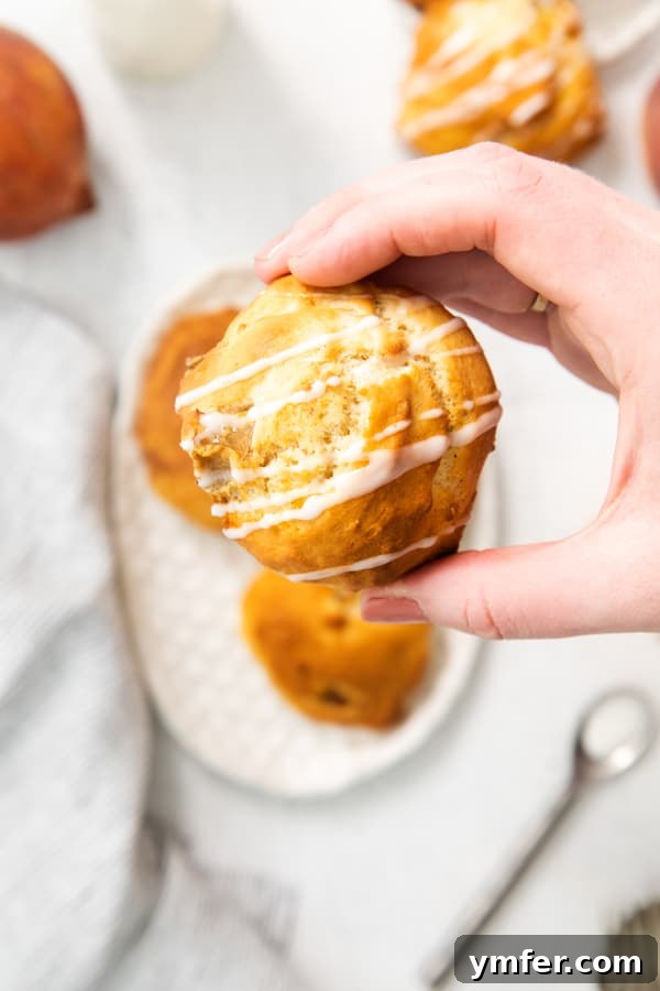 Air-Fried Peachy Delights 6 A hand holding several golden-brown air fryer peach fritters.