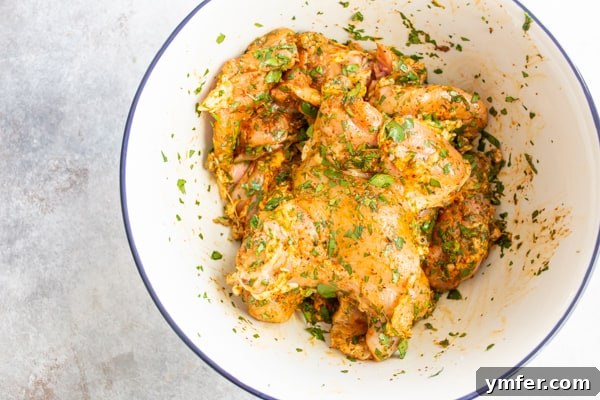 Bright Cilantro Lime Grilled Chicken Thighs 3 Chicken thighs marinating in a cilantro lime marinade.
