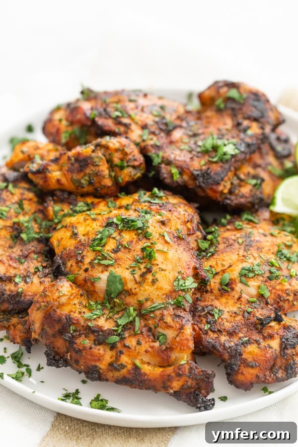 Bright Cilantro Lime Grilled Chicken Thighs 5 Grilled Cilantro Lime Chicken Thighs on a plate sprinkled with fresh cilantro.