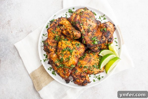 Bright Cilantro Lime Grilled Chicken Thighs 6 Grilled Cilantro Lime Chicken Thighs on a white plate.