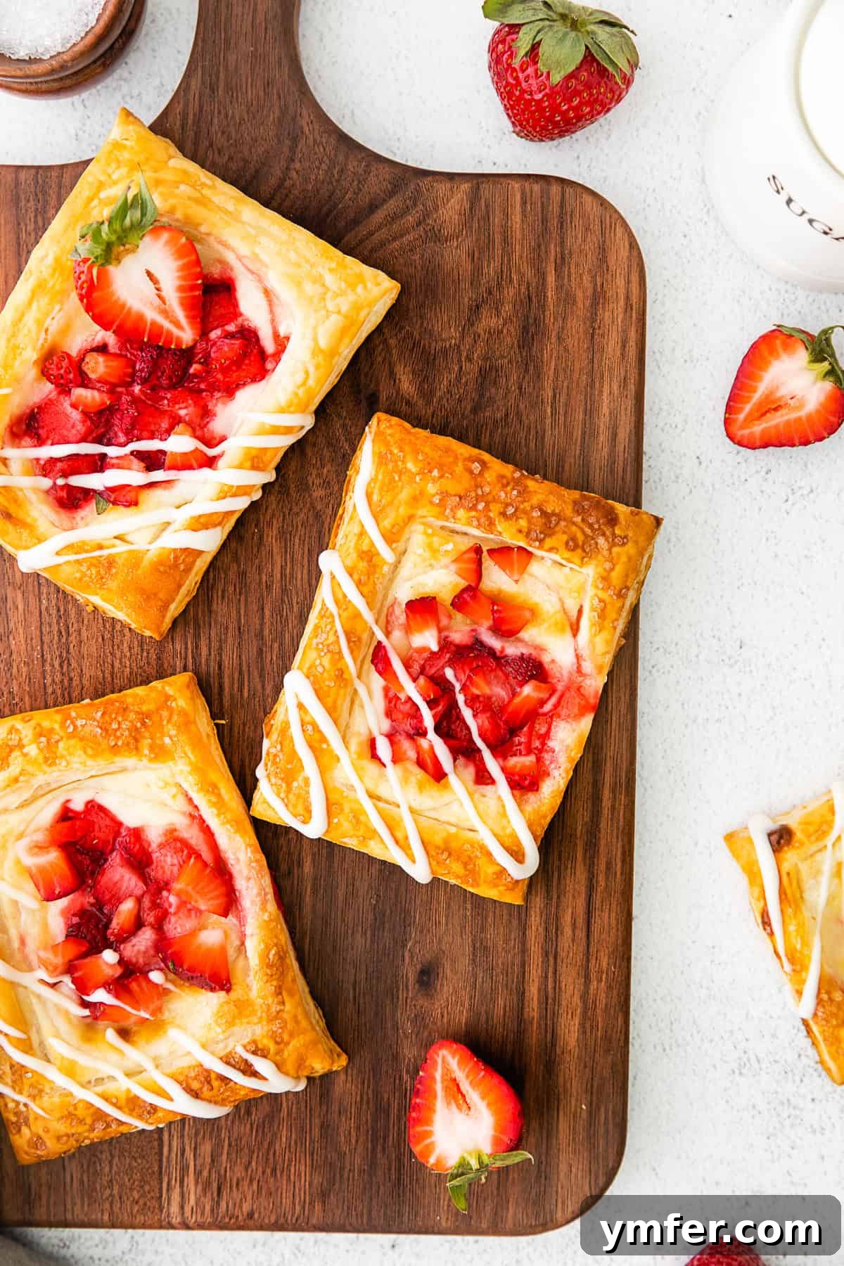 Creamy Strawberry Danish Delight 2 Easy strawberry cheesecake Danish topped with a light glaze and fresh berry slices, ready to be enjoyed.