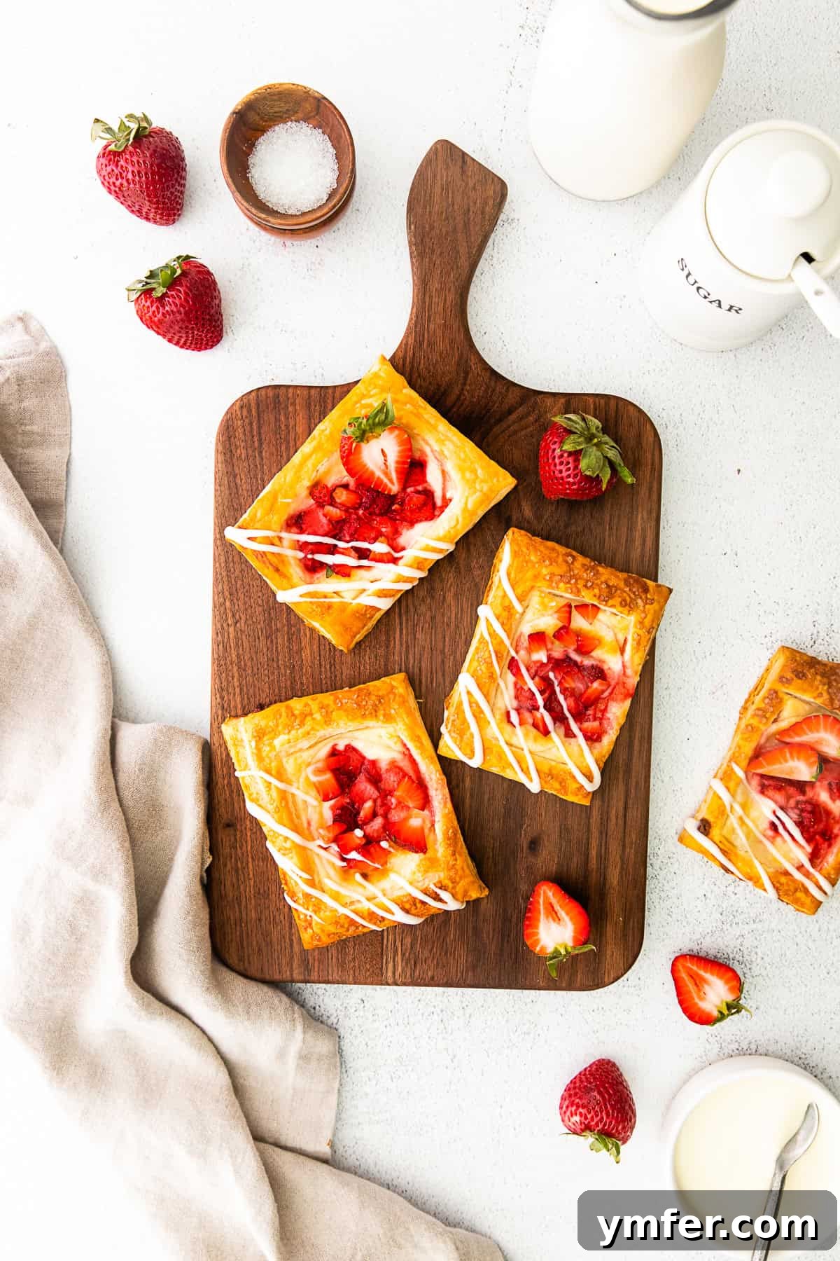 Creamy Strawberry Danish Delight 7 Easy strawberry cheesecake Danish served on a wooden cutting board, inviting you to take a bite.