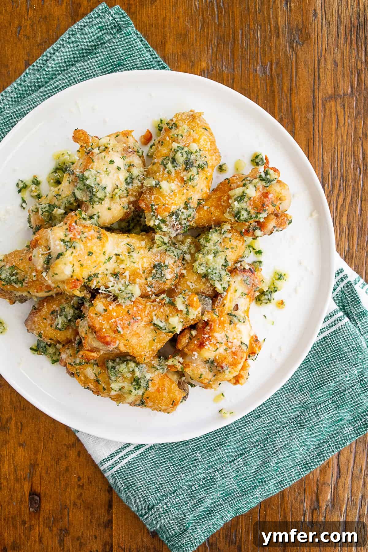 Crispy Air Fryer Garlic Parmesan Wings 2 Garlic Parmesan Chicken Wings on a white plate.