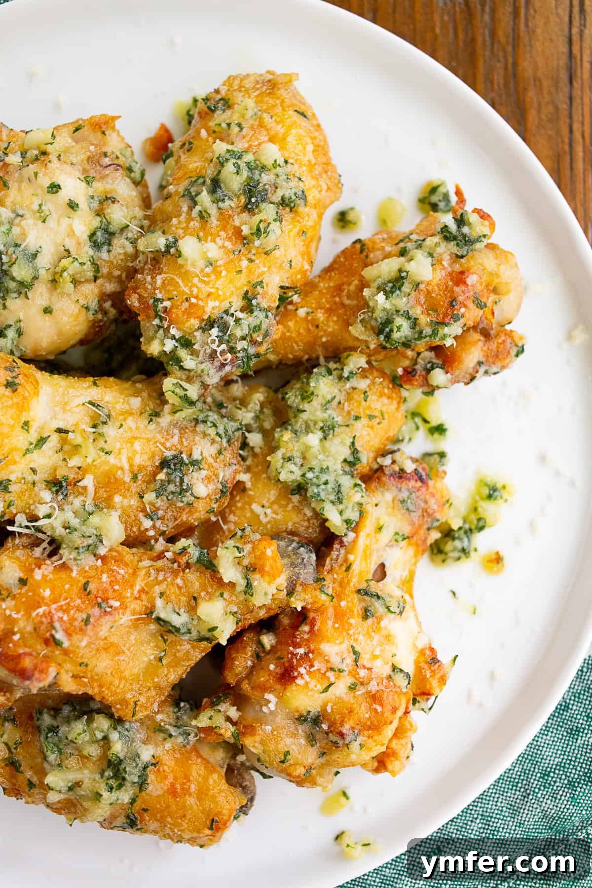 Crispy Air Fryer Garlic Parmesan Wings 4 Garlic Parmesan Chicken Wings on a plate.