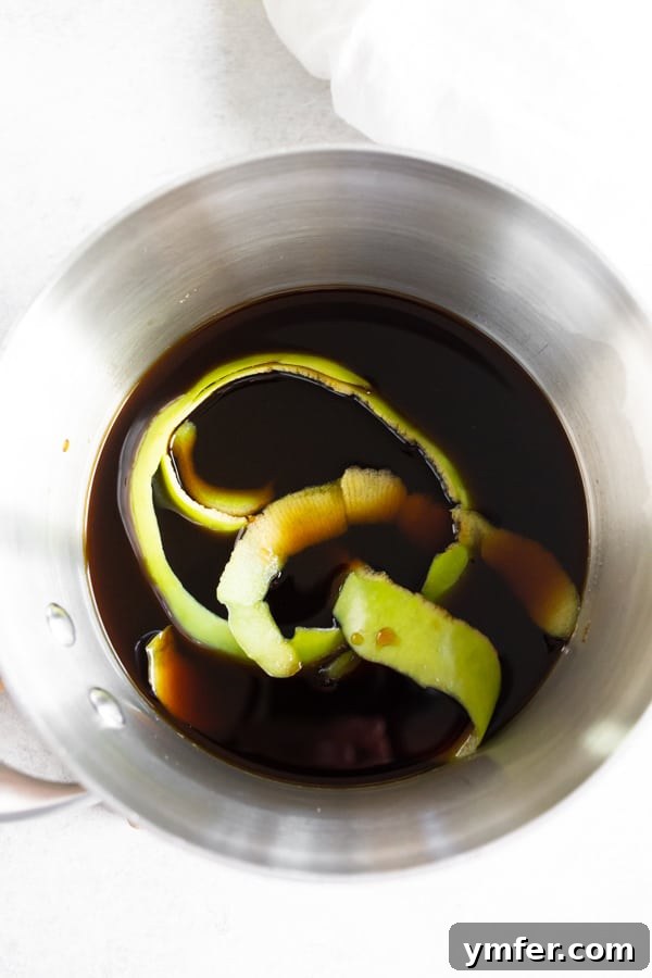 Spiced Apple Crisp Macchiato 4 The uncooked apple molasses brown sugar coffee syrup mixture simmering in a pot, showing the start of its flavor development.