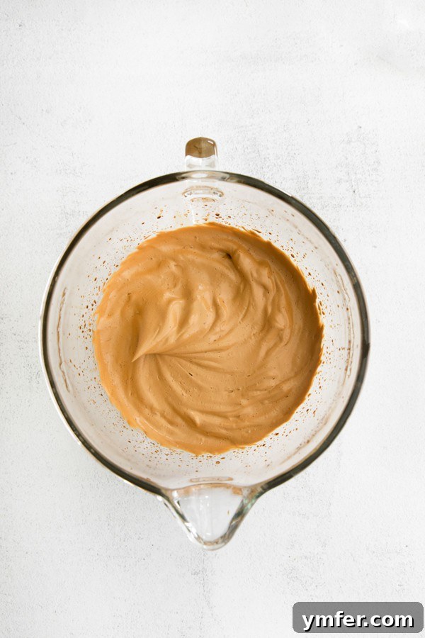 Maple Velvet Coffee 3 A close-up shot of Maple Whipped Coffee in a mixing bowl, showing its thick, creamy texture, ready to be poured over milk.