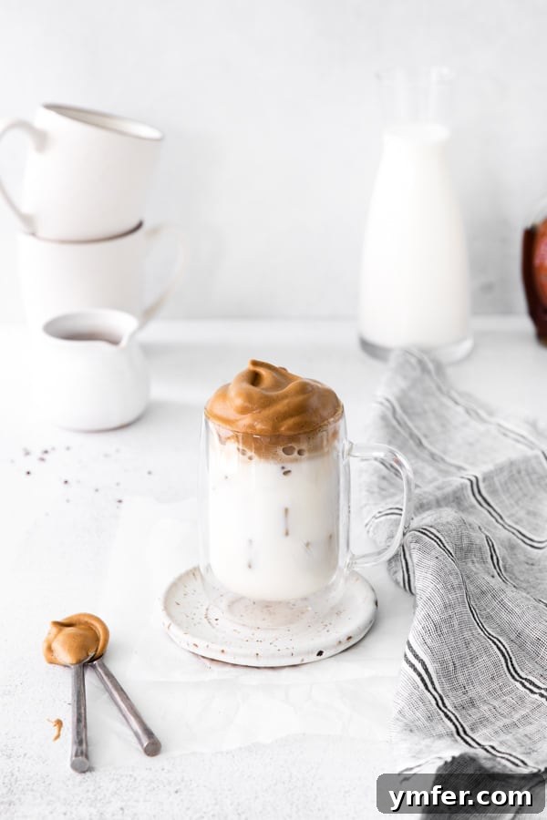 Maple Velvet Coffee 7 A beautifully presented glass of Maple Whipped Coffee with ice, adorned with the creamy foam, ready for a delightful fall drink experience.
