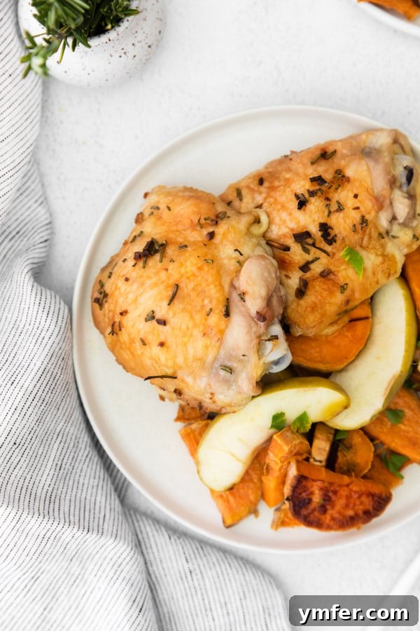 Sheet Pan Apple and Chicken Roast 3 Plated serving of Sheet Pan Chicken and Apples with Sweet Potatoes, showcasing golden chicken skin, caramelized apples, and soft sweet potatoes.