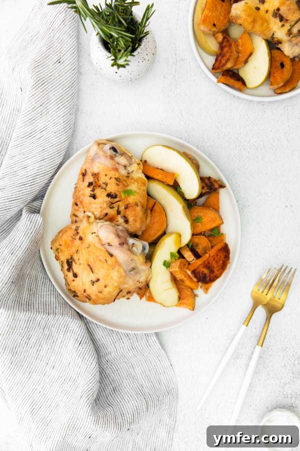 Sheet Pan Apple and Chicken Roast 5 Two plates of Sheet Pan Chicken and Apples with Sweet Potatoes, ready to be served for a cozy dinner.