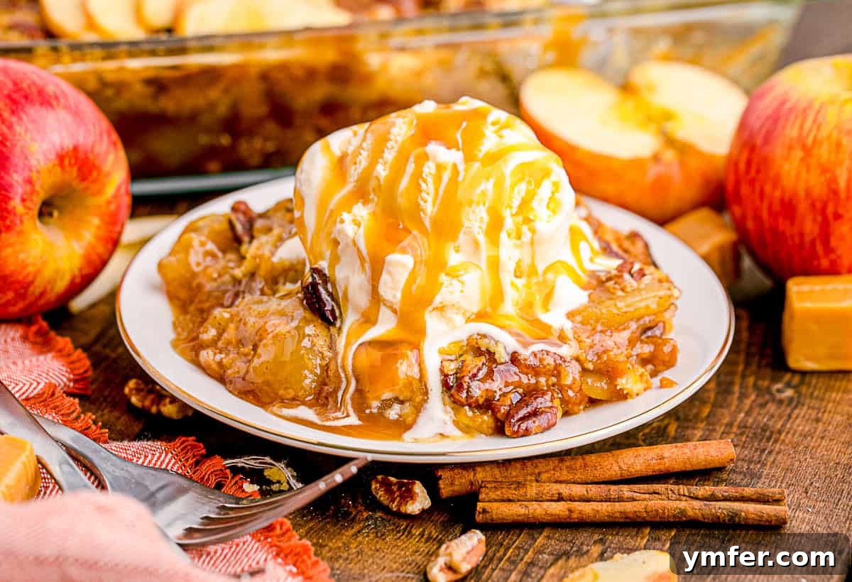 Golden Caramel Apple Bake 8 A slice of Caramel Apple Dump Cake on a white plate, accompanied by a scoop of melting vanilla ice cream and a fork, ready to be enjoyed.