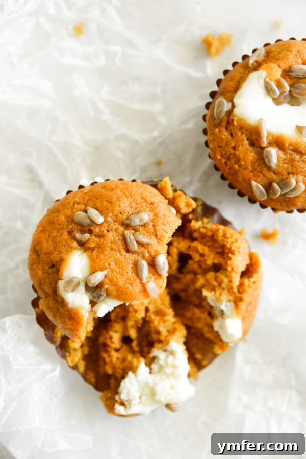 Heavenly Pumpkin Cream Cheese Swirls 5 Pumpkin Cream Cheese Muffins broken in half.