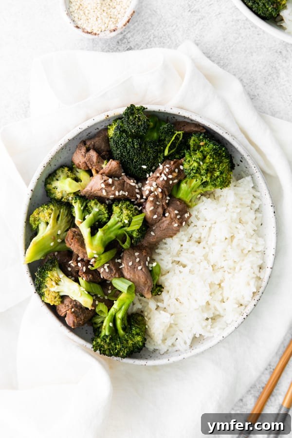 Crispy Air Fryer Beef and Broccoli 2 Air Fryer Beef and Broccoli served in a bowl with rice.