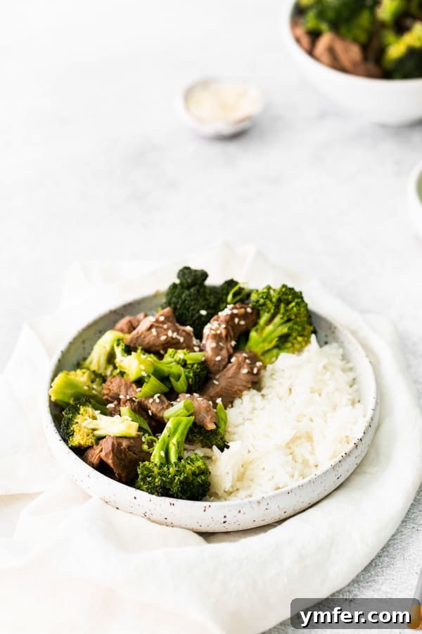 Crispy Air Fryer Beef and Broccoli 6 Air Fryer Beef and Broccoli served with white rice and sesame seeds.