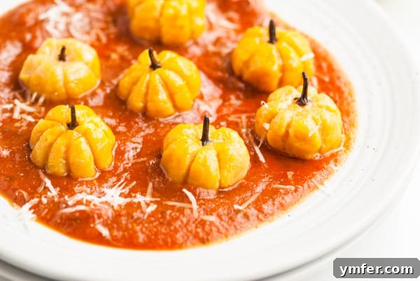 Autumn Pumpkin Gnocchi Pillows 3 A bowl of freshly cooked pumpkin shaped gnocchi, lightly coated in sauce.