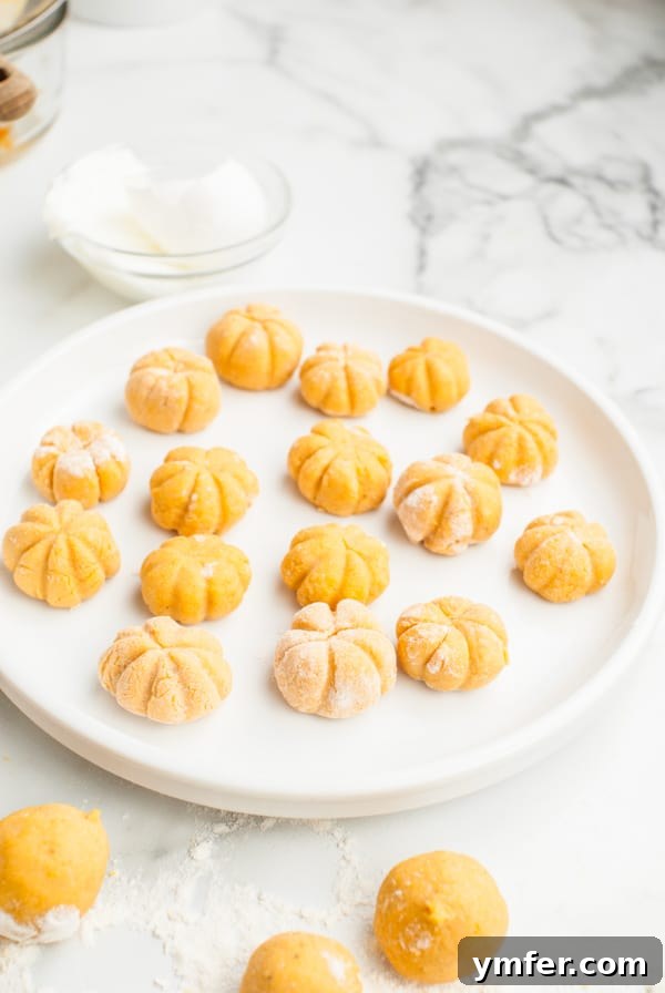 Autumn Pumpkin Gnocchi Pillows 6 A collection of perfectly shaped pumpkin gnocchi balls, ready for cooking.