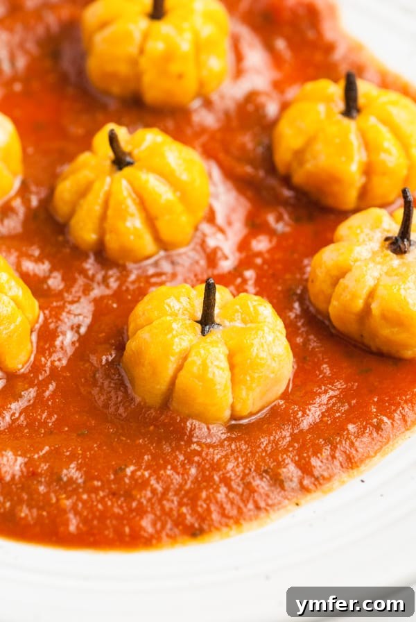 Autumn Pumpkin Gnocchi Pillows 8 Close-up of a cooked pumpkin shaped gnocchi, showing the clove stem and delicate ridges.