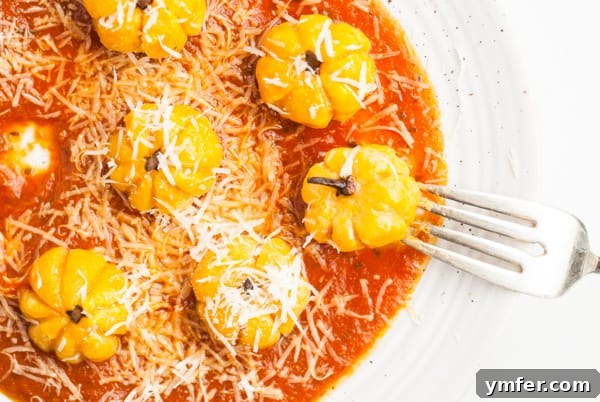 Autumn Pumpkin Gnocchi Pillows 10 Pumpkin Shaped Gnocchi on a plate, generously sprinkled with grated cheese.