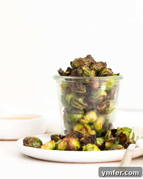 Crispy Air Fryer Brussels Sprouts 2 Air Fryer Brussels Sprouts served on a white plate.
