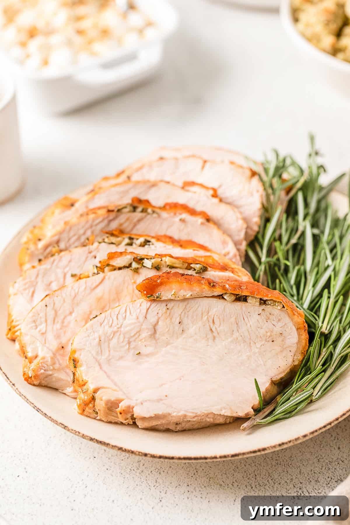 Perfectly Crispy Air Fryer Turkey Breast 7 Air Fryer Turkey Breast sliced on a plate.