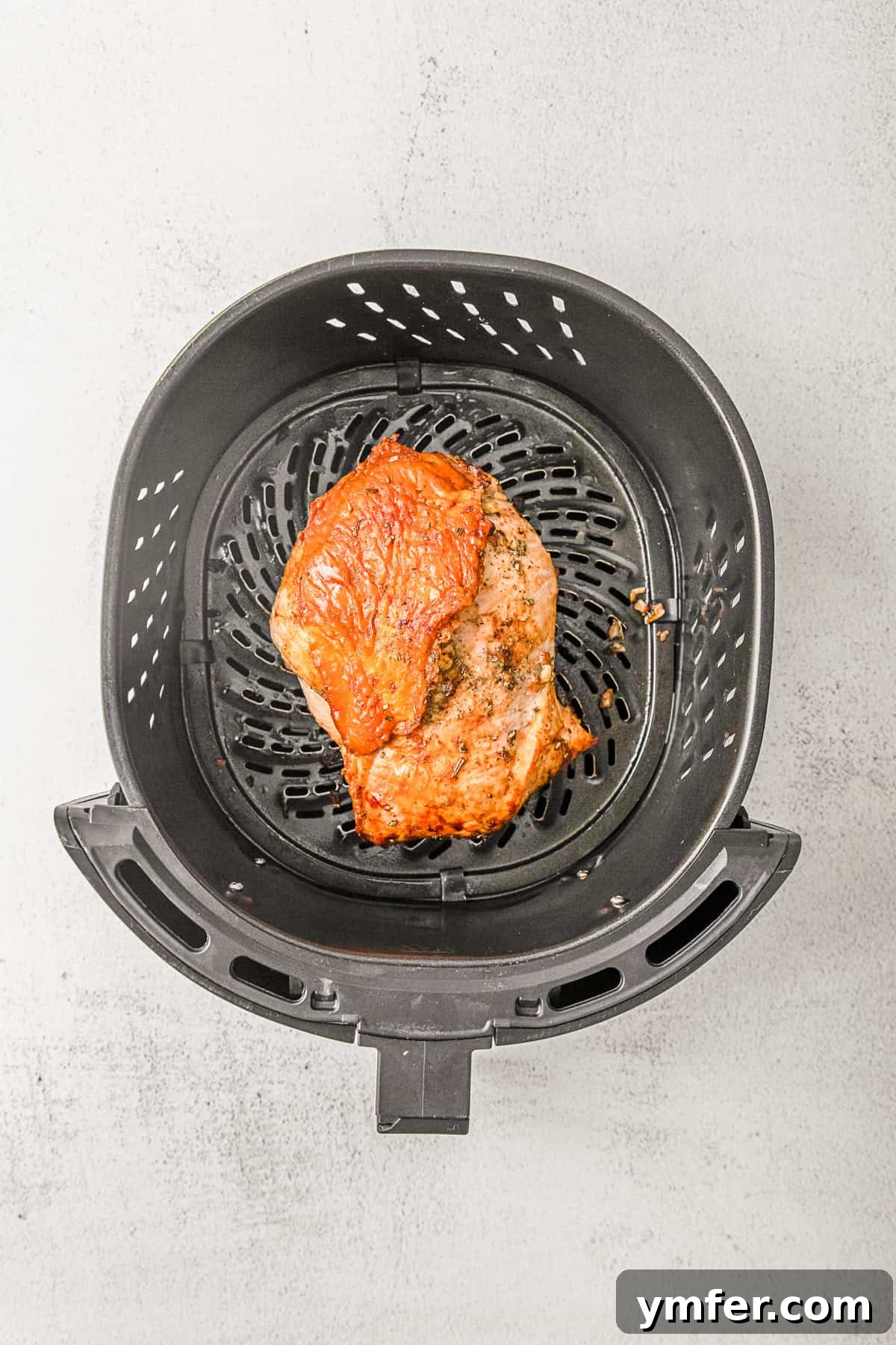 Perfectly Crispy Air Fryer Turkey Breast 3 Air fried turkey breast in an air fryer basket.