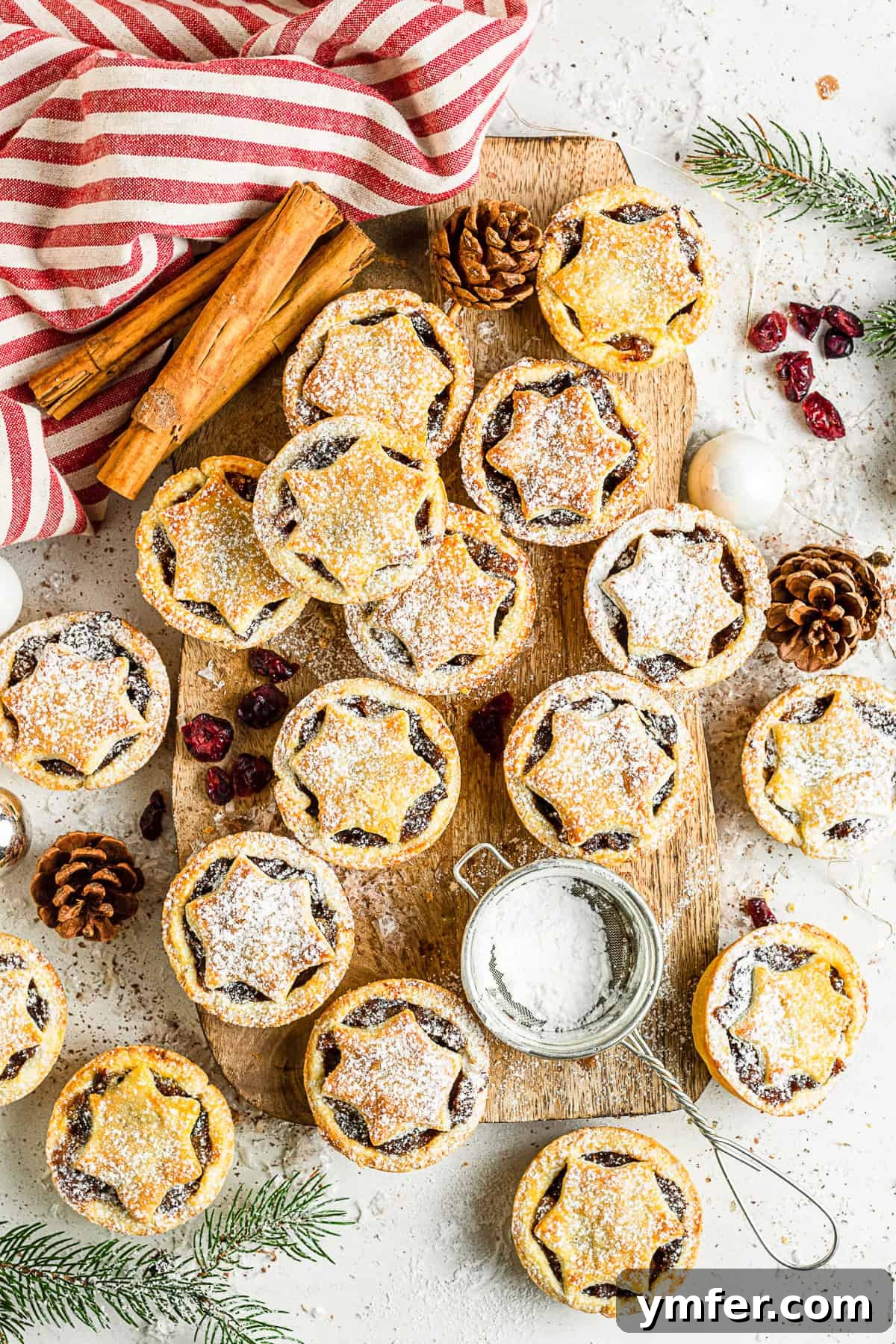 Spiced Holiday Mini Tarts 2 Mini Mincemeat Pies on a serving board.