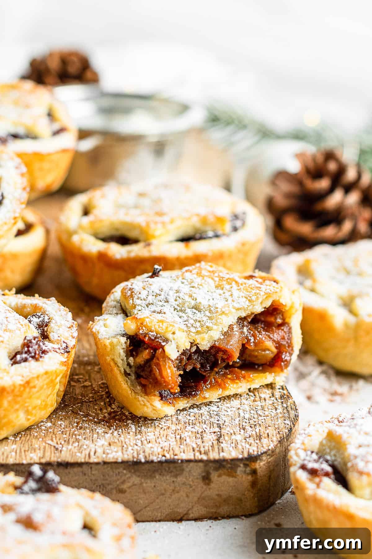 Spiced Holiday Mini Tarts 3 Mini Mincemeat Pies with a bite taken out of it.
