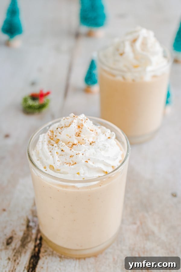A person pouring freshly made gingerbread eggnog into a glass, with a festive background.
