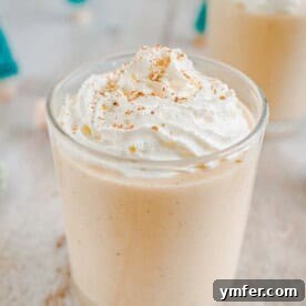 Spiced Gingerbread Eggnog served in a glass with whipped cream.