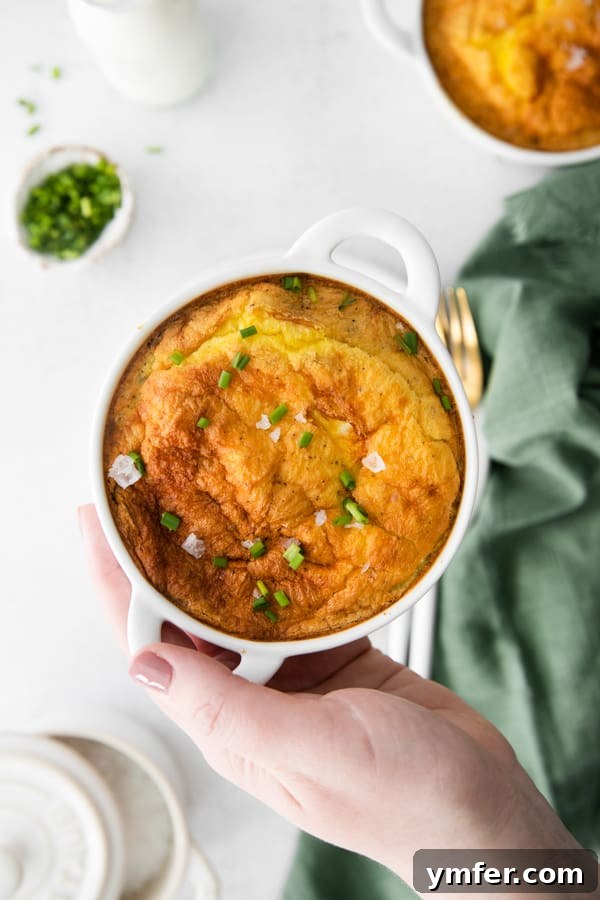 Effortless Air Fryer Frittata 2 A hand holding a ramekin of Air Fryer Frittata.