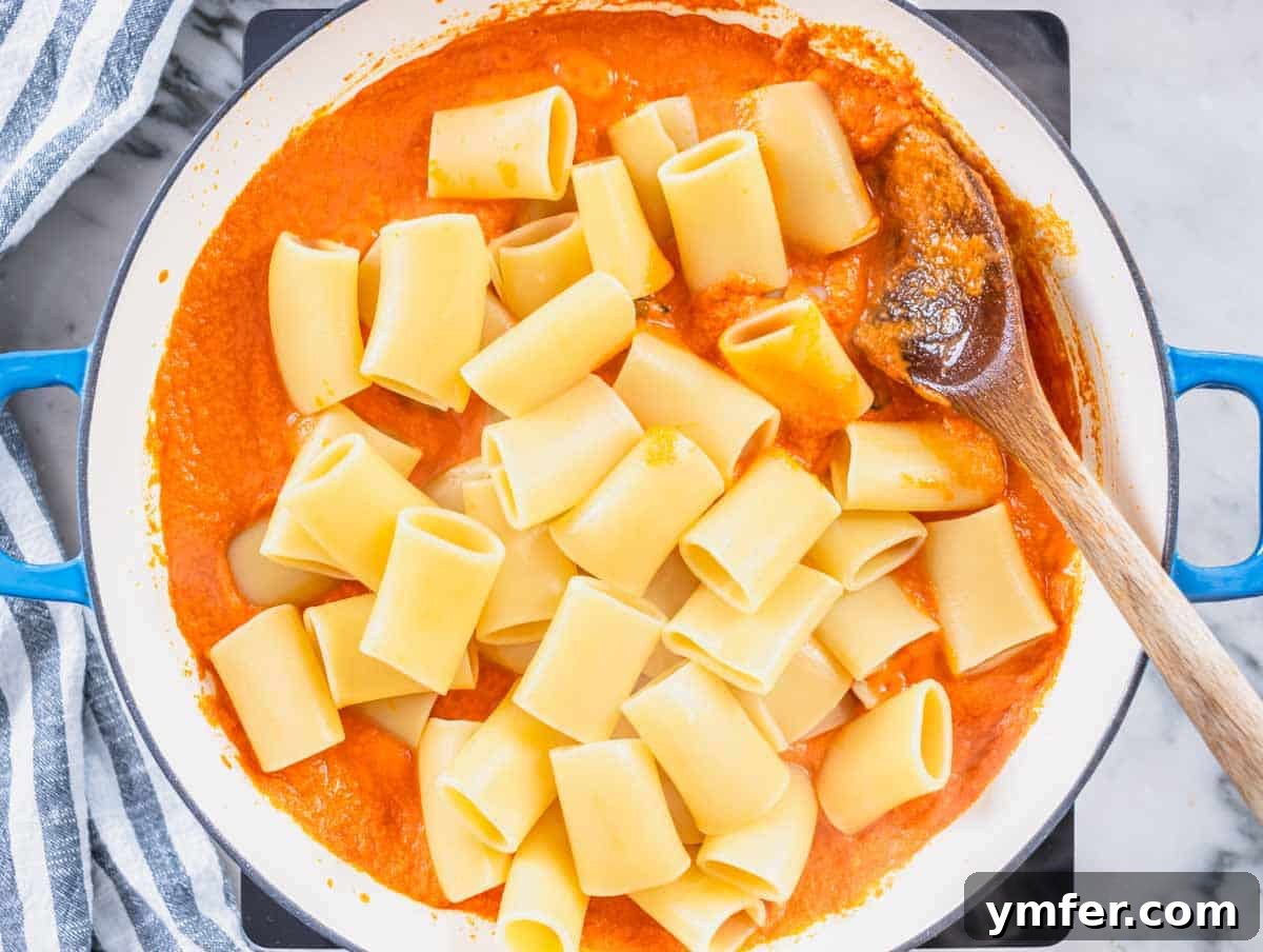 Plant-Powered Pasta 10 high protein pasta sauce with rigatoni pasta and a wooden spoon