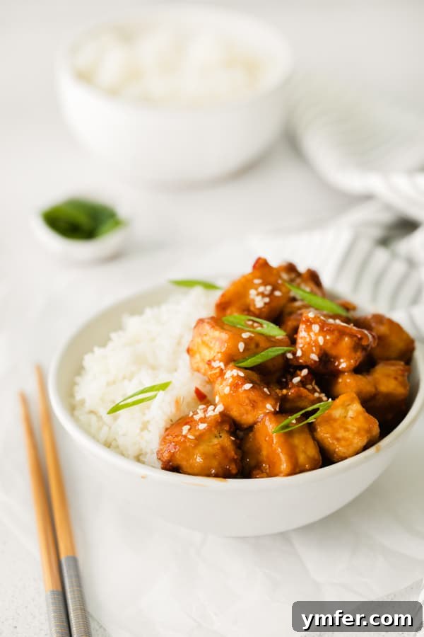 Crispy Sweet Chili Air Fryer Tofu 5 Air Fryer Sweet Chili Tofu in a bowl, generously topped with fresh green onions and sesame seeds.