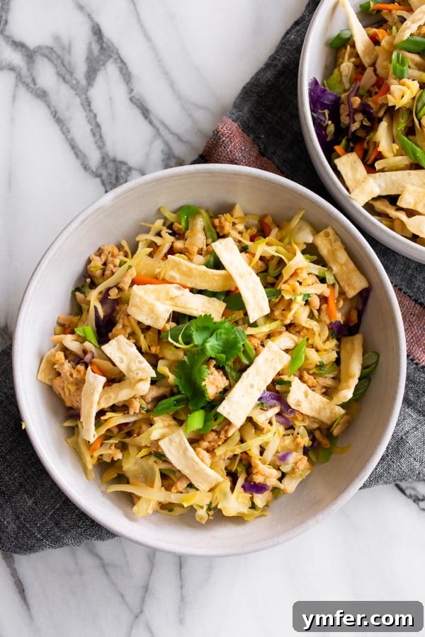 A close-up shot of the Ground Chicken Egg Roll Bowl, garnished with freshly chopped cilantro, adding a touch of color and fresh aroma to the dish.