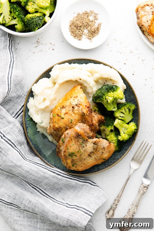 Ultimate Air Fryer Chicken Thighs 8 Air Fryer Chicken Thighs served with potatoes and broccoli.