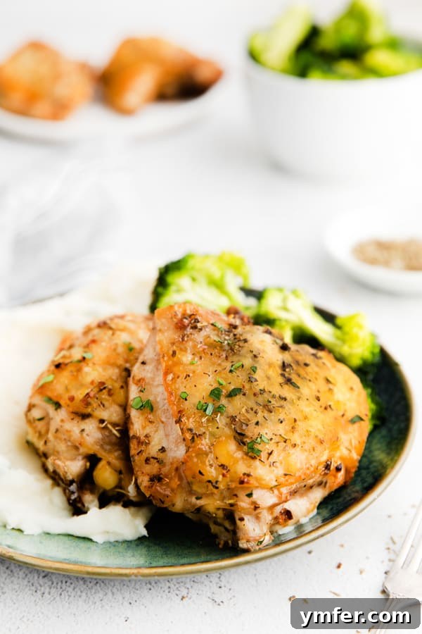 Ultimate Air Fryer Chicken Thighs 4 Air Fryer Chicken Thighs on a plate with vegetables.