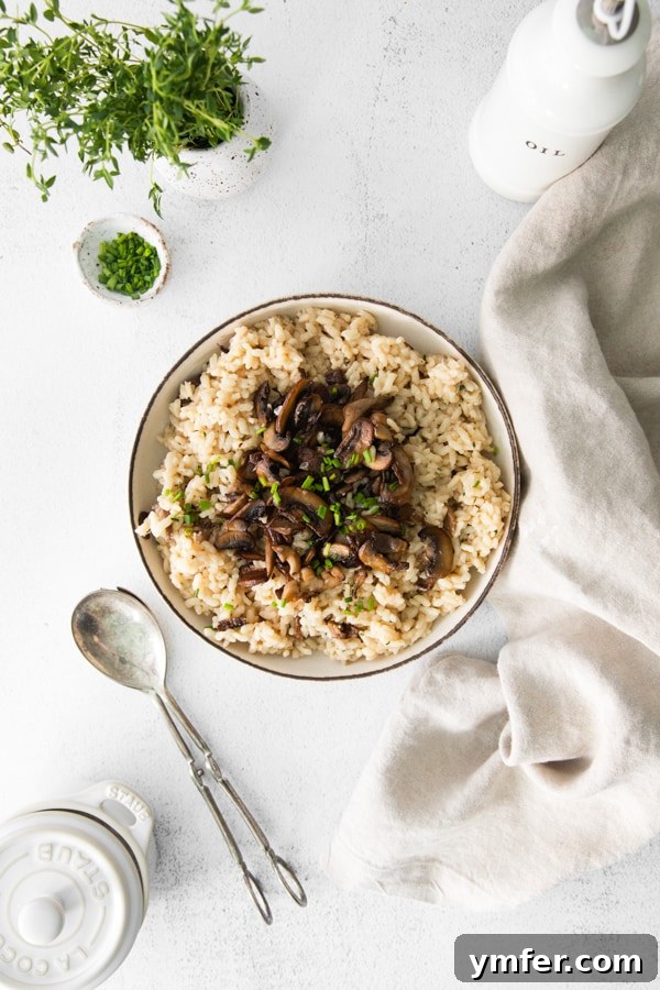 Earthy Wild Mushroom Risotto 6 A bowl of wild mushroom risotto, elegantly topped with fresh chives for a pop of color and flavor.
