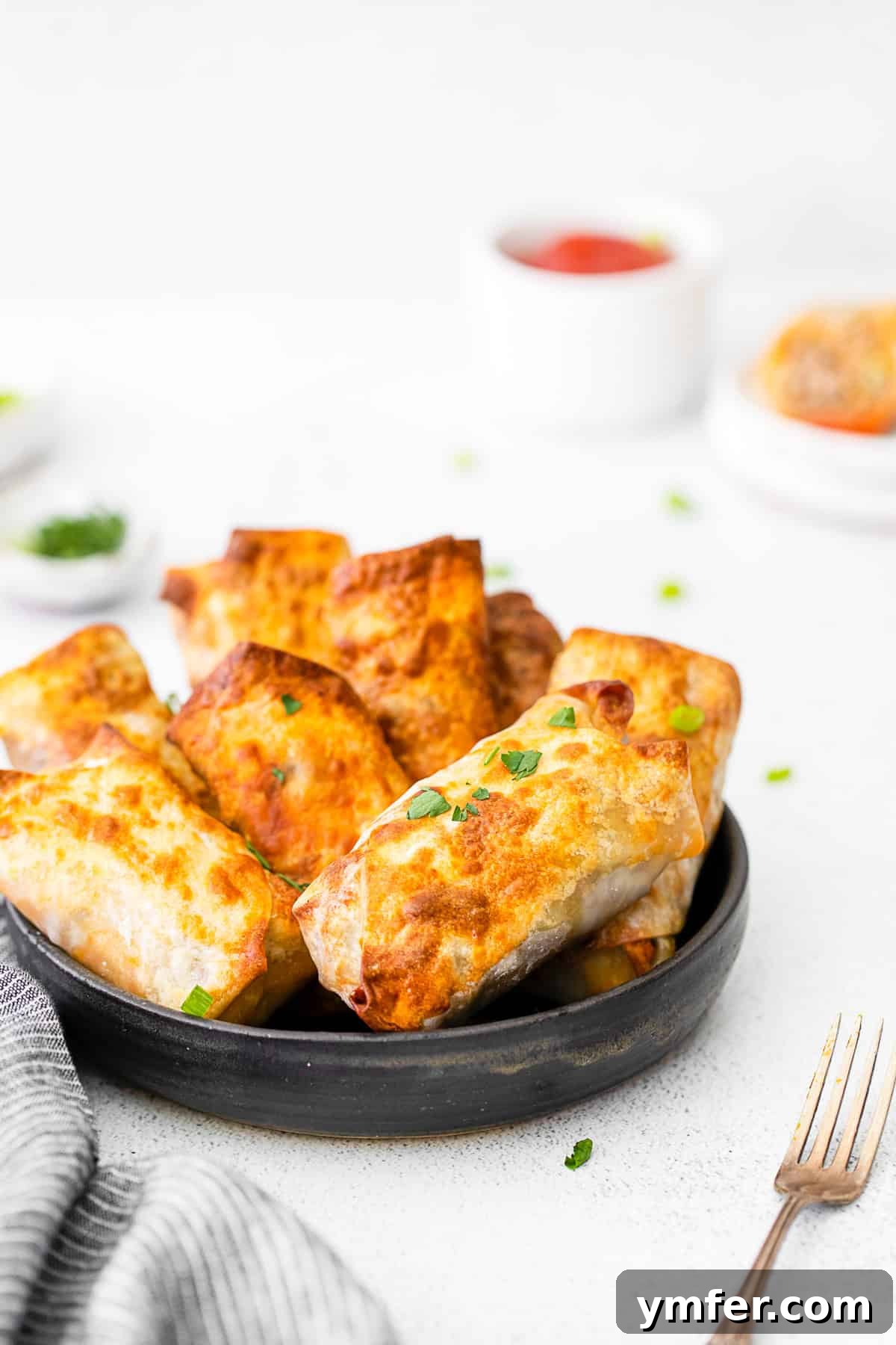 Crispy Air Fryer Cheeseburger Rolls 9 Air Fryer Cheeseburger Egg Rolls in a serving bowl.