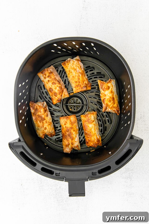 Crispy Air Fryer Cheeseburger Rolls 7 Cooked air fryer cheeseburger egg rolls.