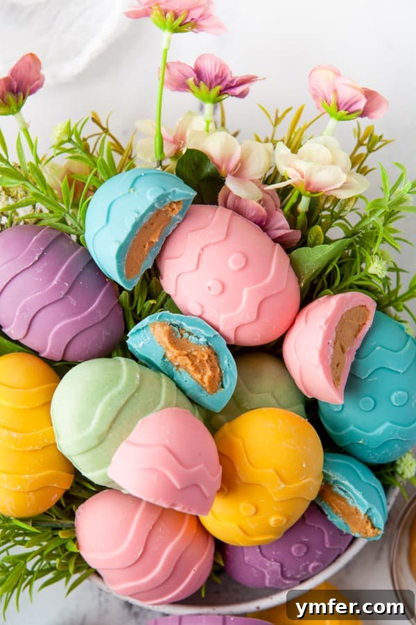 Decadent Peanut Butter Eggs 4 Peanut Butter Eggs cut in half to show filling. This image highlights the creamy peanut butter center and the vibrant candy coating, perfect for Easter treats.