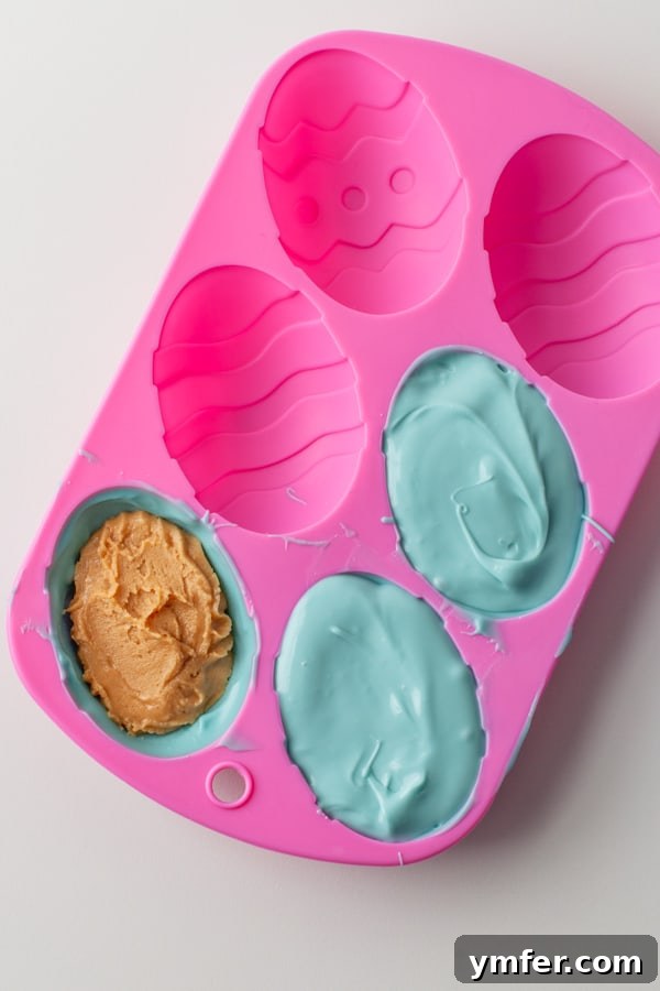 Decadent Peanut Butter Eggs 5 Close-up of a Peanut Butter Egg, showcasing its smooth, glossy finish and perfect egg shape. The vibrant color makes it ideal for Easter celebrations.