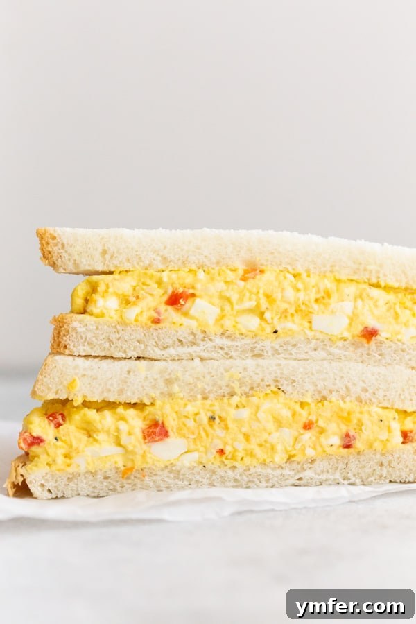 Creamy Pimento and Cheddar Egg Salad 3 A cut in half Pimento Cheese Egg Salad sandwich.