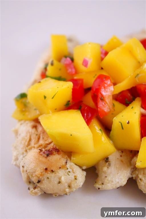 This mango salsa chicken combined fresh grilled chicken and tops it with a homemade mango salsa. It's packed with mango, pepper, cilantro and lime. 